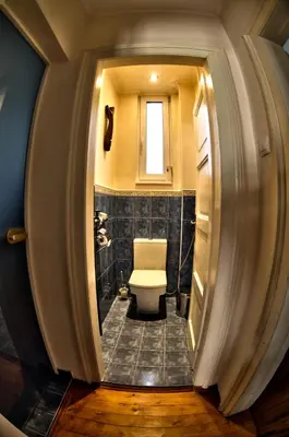 a bathroom with a toilet and a window at 66 in Sofia in Sofia