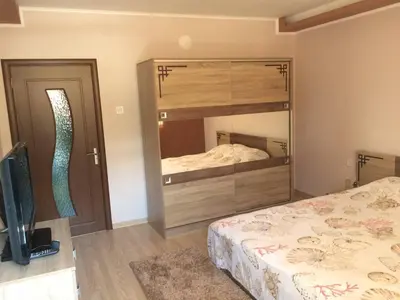 a bedroom with two beds and a large mirror at Vasilevi House in Devin