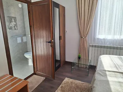 a bathroom with a toilet and a glass table at Vasilevi House in Devin