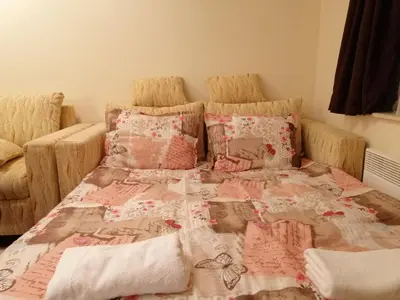a bed with a comforter and pillows on it at Studio at Home Pamporovo in Pamporovo