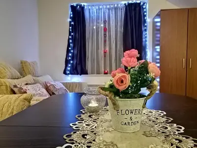 a table with a vase with flowers on it at Studio at Home Pamporovo in Pamporovo