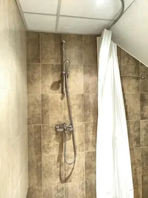 a shower in a bathroom with a shower curtain at Studio at Home Pamporovo in Pamporovo