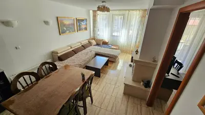 a living room with a couch and a table at Apartament Harmony in Monastery complex in Pamporovo