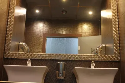 a bathroom with two urinals and a large mirror at Guest house VRAZHDEBNA in Sofia