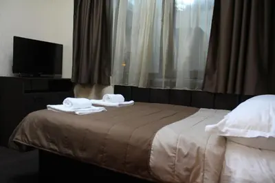 a hotel room with a bed with towels on it at Guest house VRAZHDEBNA in Sofia