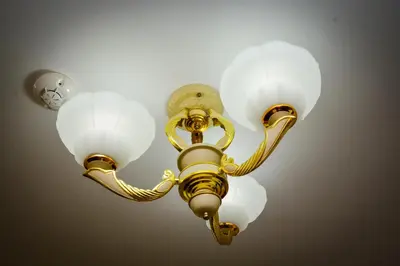 a light hanging from a ceiling with three lights at Guest house VRAZHDEBNA in Sofia