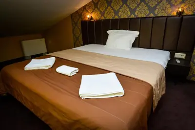 a hotel room with a bed with towels on it at Guest house VRAZHDEBNA in Sofia