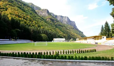 a soccer field in front of a mountain at Olymp Hotel in Teteven