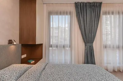 a bedroom with a bed and a window with curtains at The Grunge Spot - Charming NEW 1-Bedroom by Flat Mаnager in Sofia