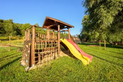 a playground with a slide in a park at Thermal Camping Velingrad in Velingrad