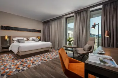 a hotel room with a bed and a desk at Hyatt Regency Sofia in Sofia
