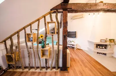 a room with a staircase and a living room at Off Vitosha Blvd Designer Apart in Sofia