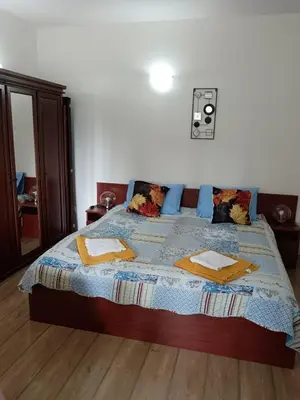 a bedroom with a bed with a blue comforter at Спа,ски апартамент Дайли, Стрийм Ризорт Пампорово in Pamporovo