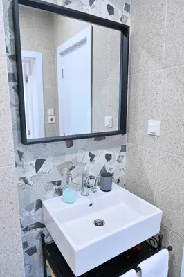 a bathroom with a white sink and a mirror at Guest House 7 in Bansko