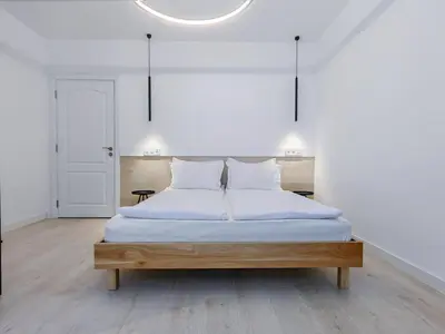 a bed with white sheets and pillows in a room at Guest House 7 in Bansko