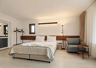 a bedroom with a bed and a chair at Guest House 7 in Bansko