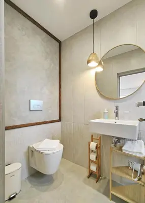 a bathroom with a toilet and a sink and a mirror at Guest House 7 in Bansko