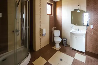 a bathroom with a toilet and a sink and a shower at Sharkov Family Hotel in Ognyanovo