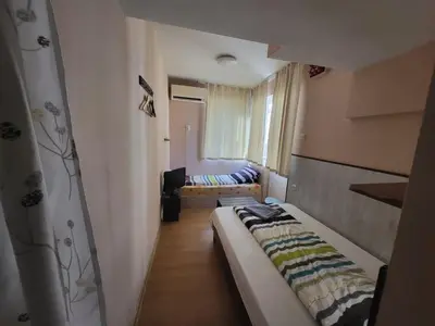 a small room with a bed and a couch at East Gate Guest Rooms in Plovdiv