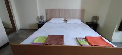 a bed in a room with two towels on it at East Gate Guest Rooms in Plovdiv