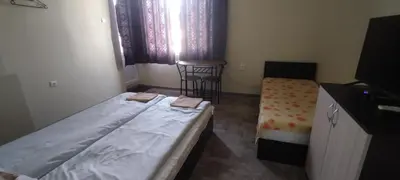 a small room with a bed and a chair in it at East Gate Guest Rooms in Plovdiv