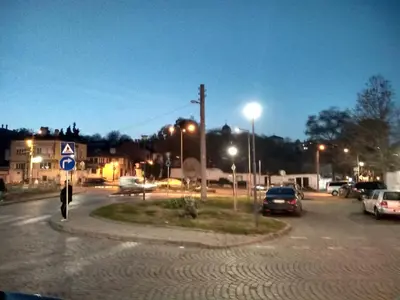 a man walking in a parking lot at night at East Gate Guest Rooms in Plovdiv