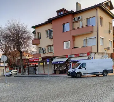 a white van parked in front of a building at East Gate Guest Rooms in Plovdiv