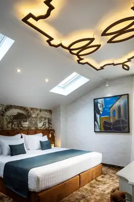 a bedroom with a large bed and a chandelier at Gallery 37 Powered by ASTON in Plovdiv