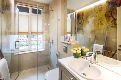a bathroom with a sink and a glass shower at Gallery 37 Powered by ASTON in Plovdiv