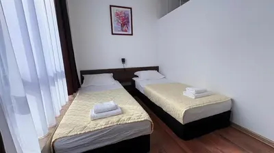two beds in a room with white towels on them at ASPEN GOLF RESORT Ski & Spa RELAX APARTMENT in Bansko