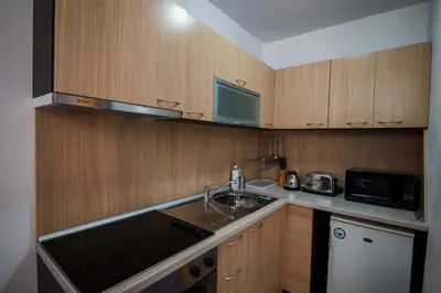 a small kitchen with a sink and a microwave at ASPEN GOLF RESORT Ski & Spa RELAX APARTMENT in Bansko