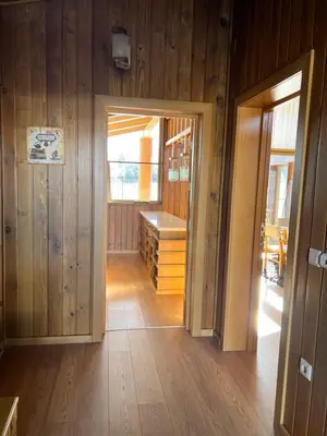 a room with wooden walls and a hallway with a door at House in Pirin Golf Bansko in Razlog