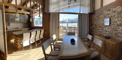 a kitchen and dining room with a table and chairs at House in Pirin Golf Bansko in Razlog