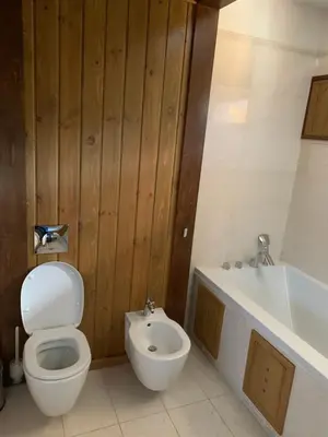 a bathroom with a toilet and a sink and a tub at House in Pirin Golf Bansko in Razlog