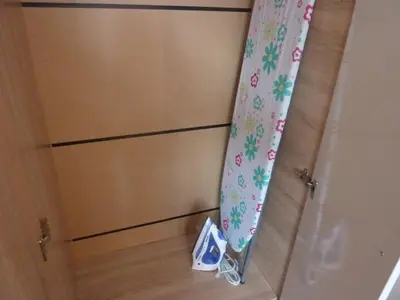 a closet with two drawers and a door with a curtain at Iskra Apartment in Sofia
