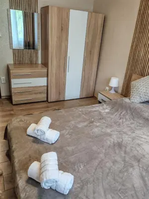 a bedroom with a large bed with towels on it at Iskra Apartment in Sofia