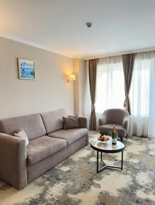 a living room with a couch and a table at Hissar Spa Hotel in Hisarya