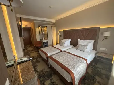 a hotel room with two beds in a room at Hissar Spa Hotel in Hisarya