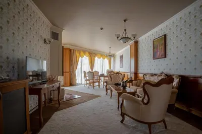 a living room with chairs and a dining room at Hissar Spa Hotel in Hisarya