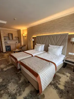 a hotel room with two beds in a room at Hissar Spa Hotel in Hisarya