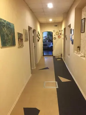 a hallway in a building with paintings on the walls at Къща за гости Спасителна in Brezhani