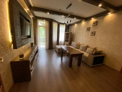 a living room with a couch and a tv at Deluxe 206 in Borovets