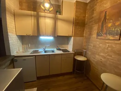 a small kitchen with white cabinets and a sink at Deluxe 206 in Borovets