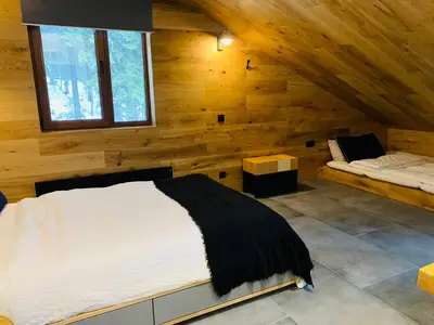 a bedroom with a bed in a wooden cabin at Silver Box Pamporovo in Pamporovo