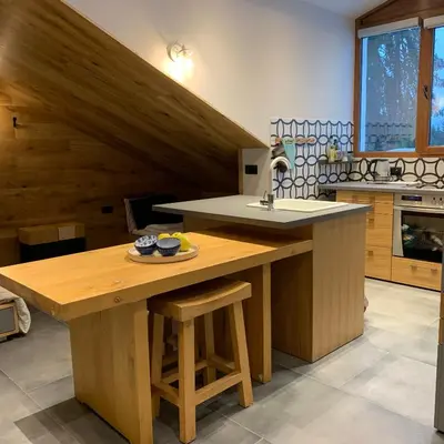 a kitchen with a wooden island with a sink at Silver Box Pamporovo in Pamporovo