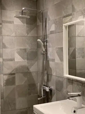a bathroom with a shower with a sink and a mirror at Silver Box Pamporovo in Pamporovo