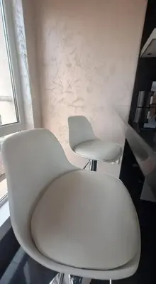 two white chairs in a room with a window at AHINORA in Plovdiv