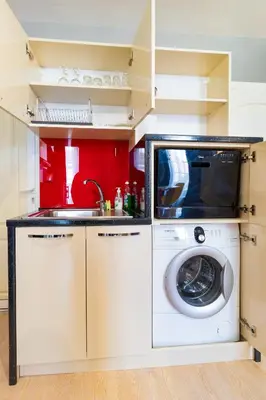 a kitchen with a washing machine and a sink at The Perfect One-Bedroom Maisonette in Plovdiv by Flat Mаnager in Plovdiv
