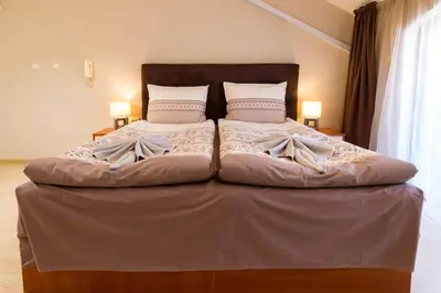 a large bed in a bedroom with two pillows on it at The Perfect One-Bedroom Maisonette in Plovdiv by Flat Mаnager in Plovdiv