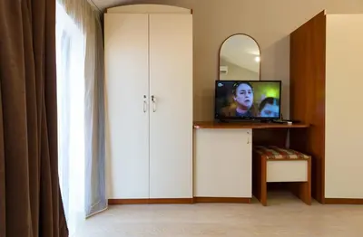 a living room with a tv and a mirror at The Perfect One-Bedroom Maisonette in Plovdiv by Flat Mаnager in Plovdiv